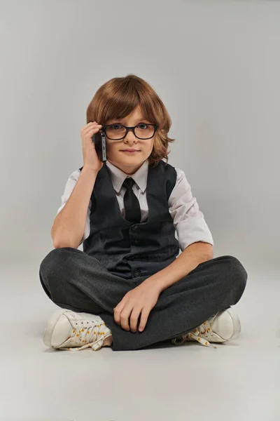 stock image A young boy exudes confidence and professionalism as he talking on his phone, future businessman