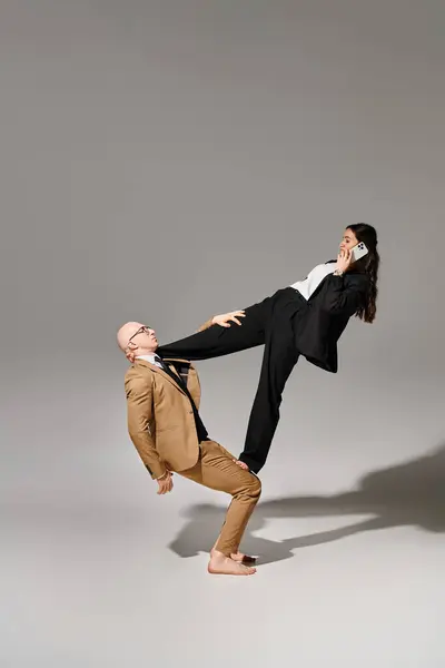 Businesswoman Smartphone Calling Balancing Help Man Grey Couple Acrobats — Stock Photo, Image