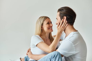 A man and a woman sitting closely, deep in conversation, sharing a moment of intimate connection. clipart