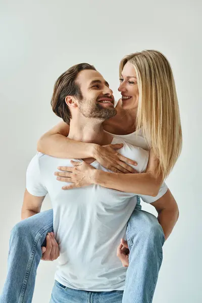 Blonde Woman Tenderly Holds Man Her Arms Passionate Display Romance — Stock Photo, Image
