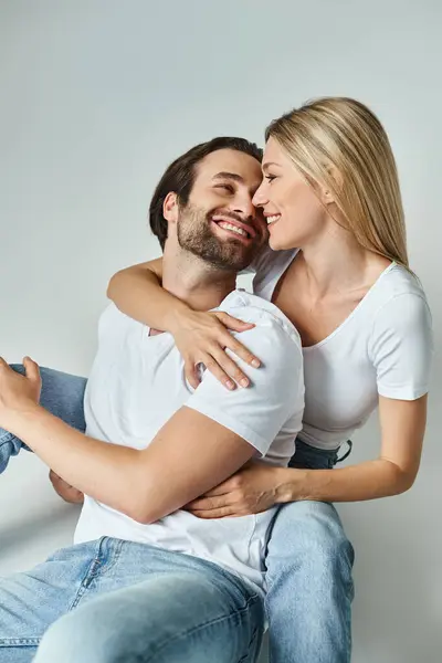 stock image A man and woman entwined, seated intimately, embodying a passionate connection between two hearts.