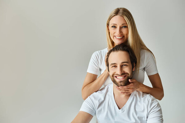 couple engage in a romantic embrace as the woman touching head of her man, symbolizing unity and passion.