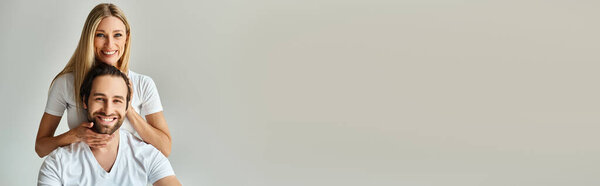 A man sits regally on top of a womans head, symbolizing their intertwined connection and shared love.