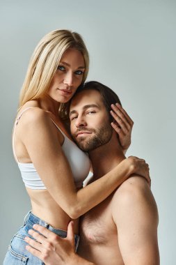 A sexy couple, passionately entwined in a loving embrace. clipart