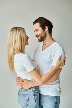 A man and woman passionately embrace each other, showing undeniable love and romance. clipart