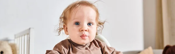 stock image portrait of cute adorable little child boy looking at camera in nursery room at home, banner