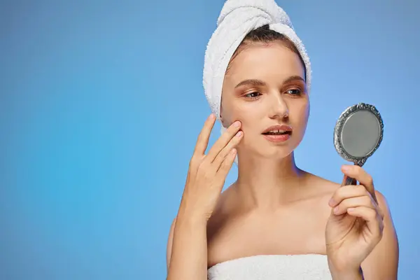 stock image attractive woman with towel on head touching perfect skin on face on yellow backdrop, beauty