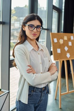 A businesswoman with glasses in a modern office, embodying the concept of franchising. clipart