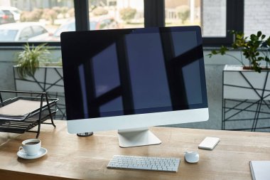 A sleek desktop computer rests atop a wooden desk in a modern office setting, embodying a tech-savvy and organized workspace. clipart