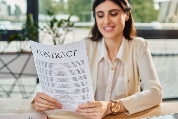 A businesswoman sitting at a table, deeply engrossed in reading a contract, surrounded by the modern elegance of her office space.