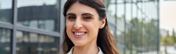 A modern businesswoman with long hair wearing a white shirt, embodying professionalism and elegance in a franchise concept.