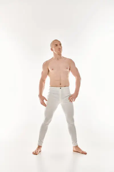 Young Man White Pants Strikes Dynamic Pose Showcasing Acrobatic Elements — Stock Photo, Image