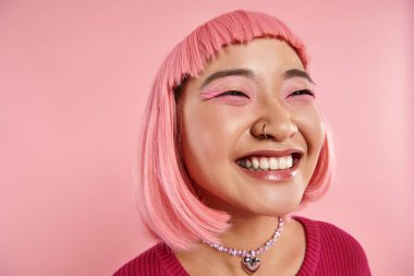 close up of asian young woman with nose piercing happy laughing on pink background clipart