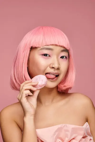 Portrait Playful Asian Woman Pink Hair Licking Mochi Vibrant Background — Stock Photo, Image