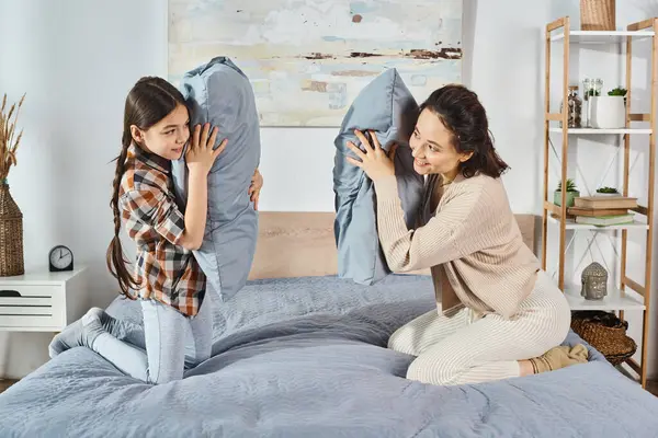 一位母亲坐在她年幼女儿旁边的床上 在家里共度快乐时光 — 图库照片