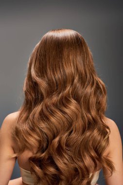 The back of a womans head featuring beautiful, long, wavy hair cascading down effortlessly. clipart