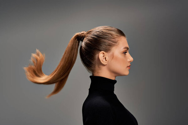 Молодая женщина с длинными волосами, выдержанными в хвосте, излучает элегантность и изящество на этом портрете..