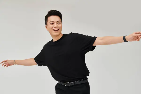 Fashionable Young Man Black Shirt Pants Strikes Dynamic Pose Elegant — Stock Photo, Image