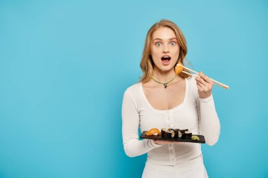 Appealing woman elegantly holds a tray of sushi and chopsticks, showcasing her culinary expertise with a touch of sophistication. clipart