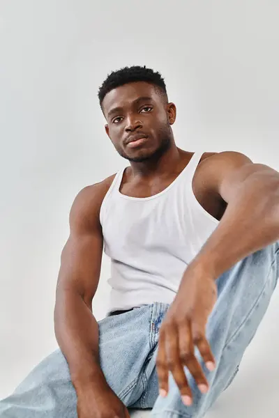 Young African American Man White Tank Top Sits Ground Contemplative — Stock Photo, Image