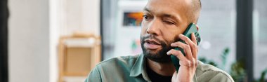 A disabled man with myasthenia gravis engaged in a phone conversation while immersed in the corporate culture of a bustling office setting. clipart