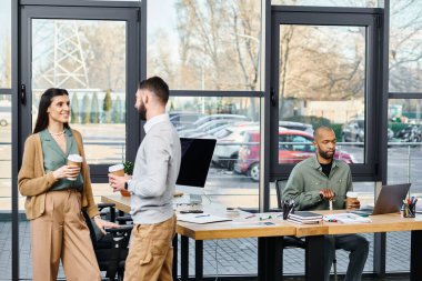 A diverse group of professionals brainstorm ideas and work on a project together around a wooden table in an office setting. clipart