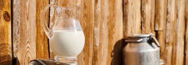 object photo of churn and jar of fresh milk placed outside of village house on modern farm, banner clipart