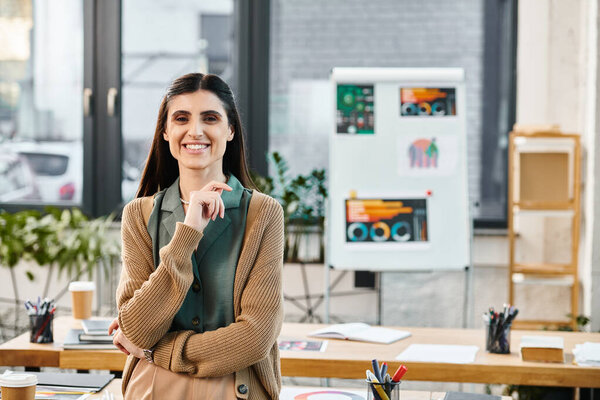 A woman stands confidently in her office, ready to tackle the days projects in a corporate setting.