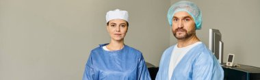 A man and woman in scrubs stand side by side. clipart
