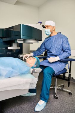 Attractive surgeon performing laser vision correction on womans face. clipart