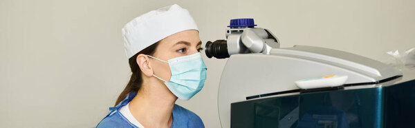 Woman with surgical mask holding laser vision correction machine.