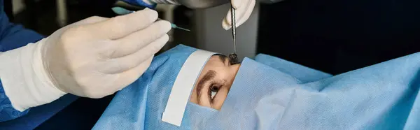 stock image Doctor performing laser vision correction on womans face.
