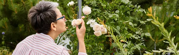 Appealing Mature Jolly Woman Glasses Cozy Attire Smelling Roses While — Stock Photo, Image
