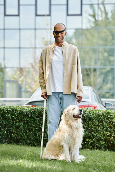 A disabled African American man standing alongside a Labrador dog on a lush green field, symbolizing harmony and inclusivity.