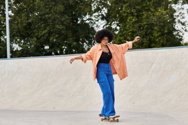A young African American woman with curly hair confidently rides a skateboard at a vibrant skate park. clipart
