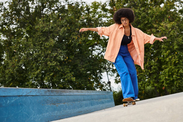 A young African American woman with curly hair skillfully riding a skateboard down the side of a ramp in a vibrant skate park.