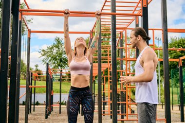 A man and woman, in sportswear, are standing in front of a gym, exuding determination and motivation, personal trainer. clipart