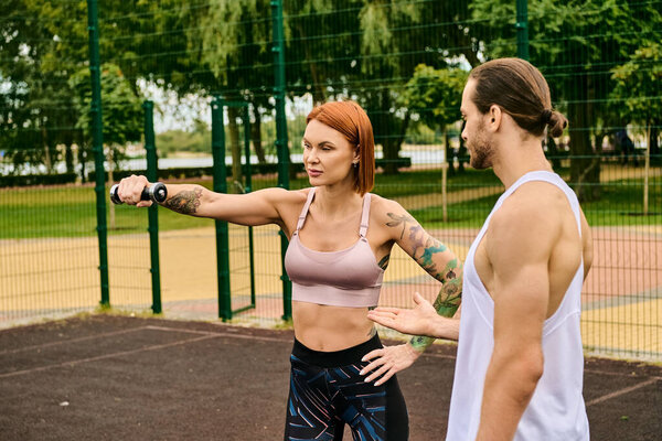 A woman in sportswear, guided by a personal trainer, display determination and motivation
