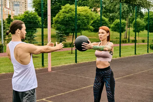 Man Woman Sportswear Playfully Exercise Ball Outdoors Showcasing Determination Motivation — Stock Photo, Image