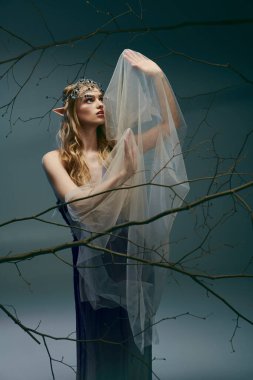 A young woman dressed as an elf princess stands gracefully in front of a majestic tree wearing a veil. clipart