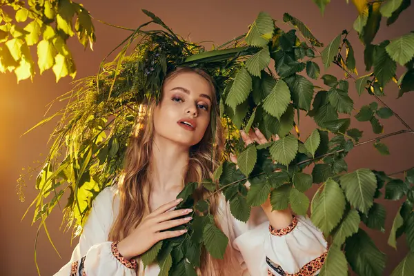 stock image A young mavka in traditional attire wearing a wreath of leaves, exuding a mystical and whimsical aura in a studio setting.