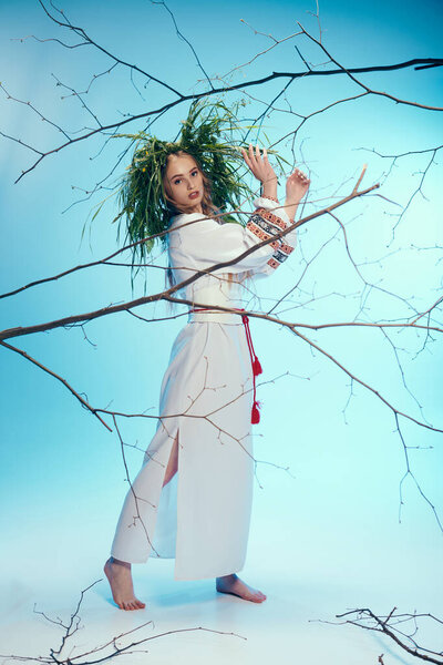 A young woman in a white dress gracefully holds a delicate branch, embodying serenity and connection to the natural world.