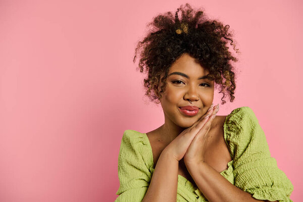Stylish African American woman poses elegantly in a vibrant yellow dress.