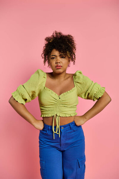 Stylish African American woman with hands on hips in dynamic pose.