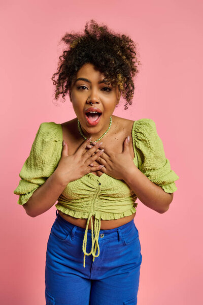 Афроамериканка в стильной одежде выглядит удивленной.