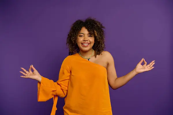 Stylish African American Woman Orange Top Holds Out Hands — Stok fotoğraf