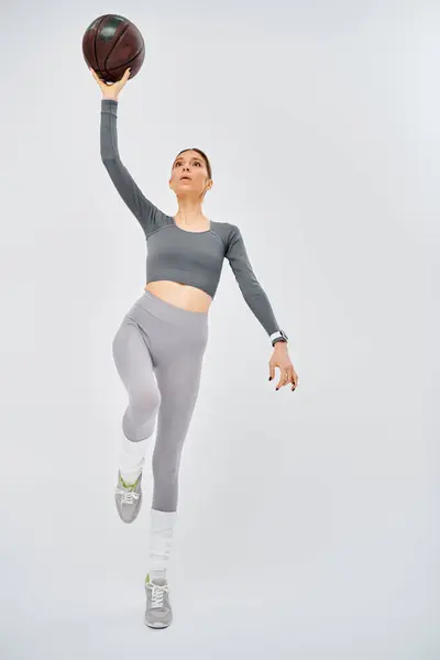 Sporty Young Woman Active Wear Confidently Holds Basketball Air Grey — Stock Photo, Image