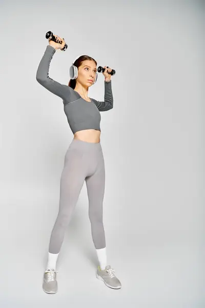 Sporty Young Woman Active Wear Exercising Dumbbells Grey Background Royalty Free Stock Photos