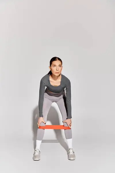 Sporty Young Woman Working Out Resistance Band Grey Background — Stock Photo, Image