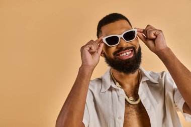 A man with a stylish beard and trendy sunglasses exudes confidence and charisma as he poses for the camera. clipart